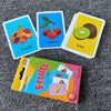 A set of colorful flash cards featuring fruits like strawberry, cherry, and kiwi for early learning.