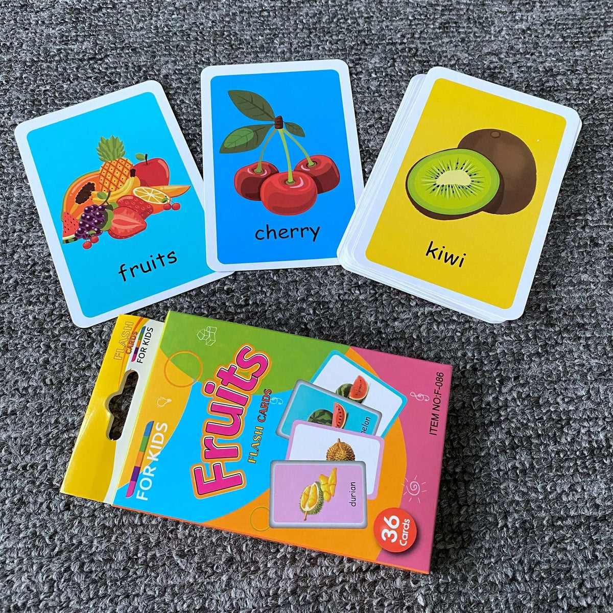 A set of colorful flash cards featuring fruits like strawberry, cherry, and kiwi for early learning.