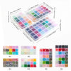 A collection of smooth round glass beads in various colors and shades arranged in small plastic containers.