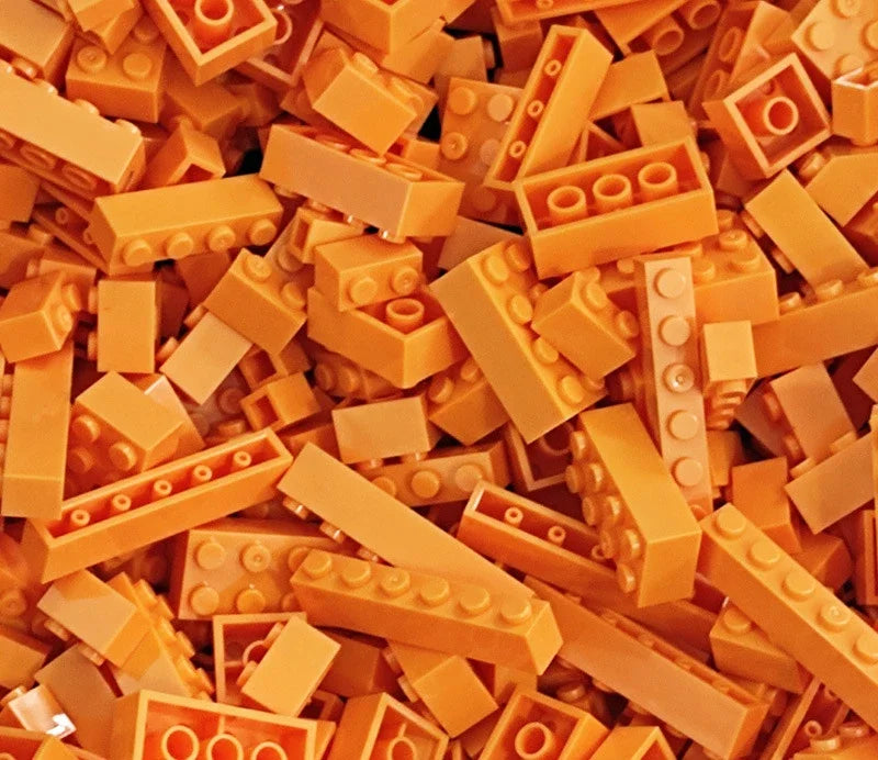 A pile of colorful plastic building blocks in various shapes and sizes.
