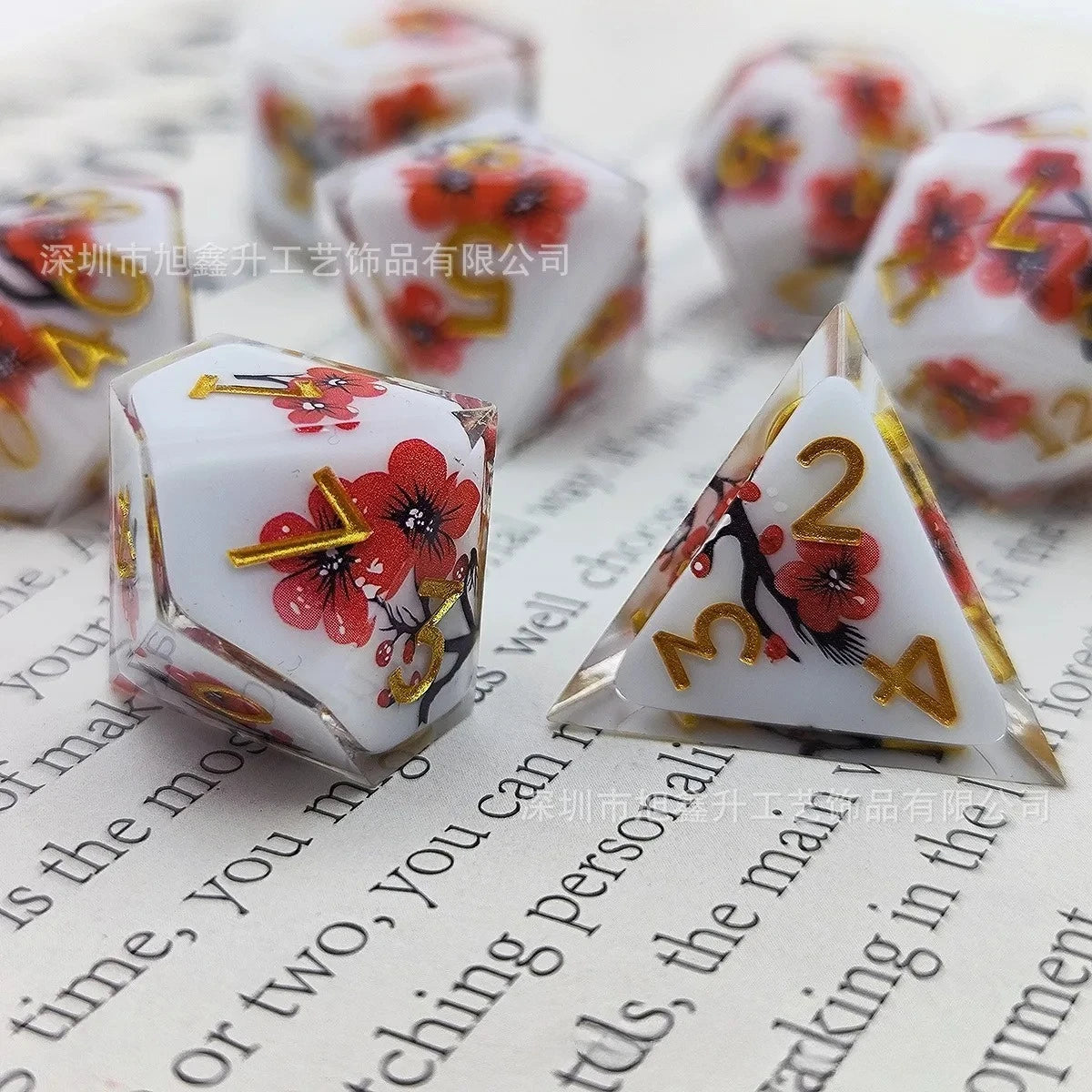 A set of milk white resin dice featuring a black kitten design, arranged on a piece of paper.
