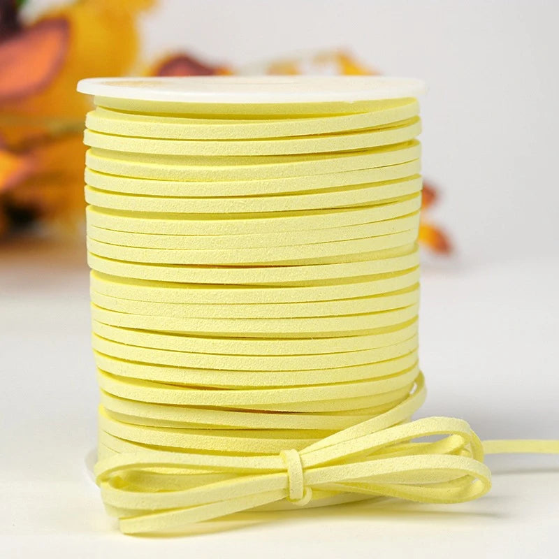 A stack of bright yellow velvet faux suede braided ribbon rolls for crafting and gift wrapping.