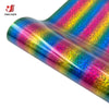 Close-up of iridescent glitter holographic heat transfer vinyl fabric rolled and draped, showing vibrant rainbow colors.