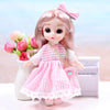 A pink articulated princess doll with a pink and white striped dress and a pink bow, standing next to a white vase and a purp