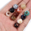 A collection of 10 translucent and opaque acrylic cloud beads in various natural and pastel colors are displayed on a hand.