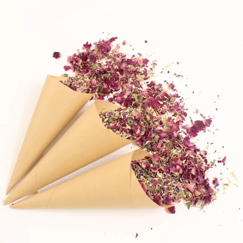 Dried rose petal confetti scattered from a rolled paper cone