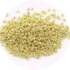 A pile of small, gold-colored metallic glass beads for jewelry making.