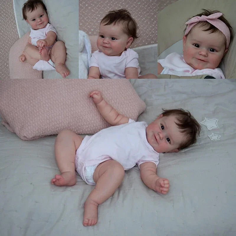 A photo of a lifelike reborn baby doll named Maddie with soft body and detailed 3D skin lying on a white surface.