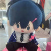 A plush doll of an anime character with blue hair and dark clothing sitting down.