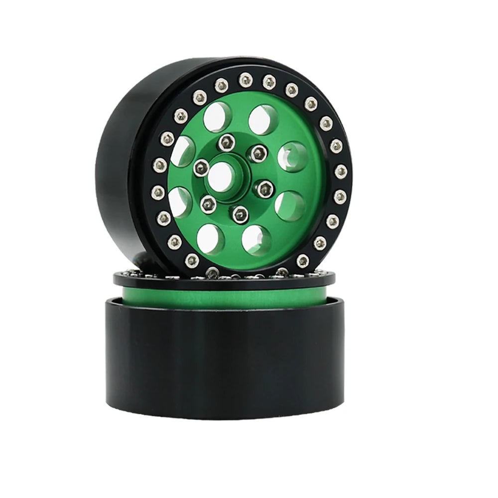 Black beadlock wheels with a green center and removable hex hub for an RC crawler.