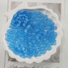 A pile of oval blue glass rice grain beads for jewelry making