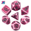 A set of pink and purple retro polyhedral dice showing various numbers like 5, 6, 8, 10, and 12.