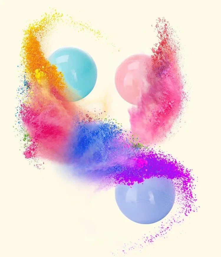 A vibrant explosion of colored powder and light blue play balls against a white background.