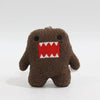 A dark brown, fuzzy plush charm shaped like a monster with a wide open mouth showing sharp teeth.