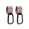 A pair of pink and black heavy-duty stroller hooks for hands-free organization.