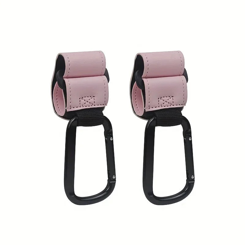A pair of pink and black heavy-duty stroller hooks for hands-free organization.