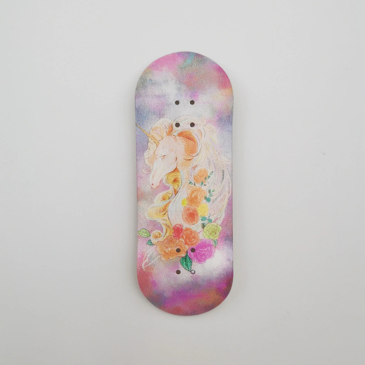A wooden fingerboard deck with a UV-printed graphic of a white unicorn and colorful flowers on a purple background.