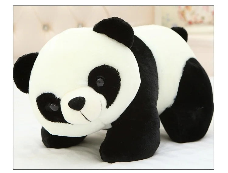 A white and black panda plush pillow with a soft texture is shown in a close-up view.
