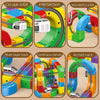 A collection of magnetic building blocks and train tracks showing various orbits, intersections, bends, and arched tracks.