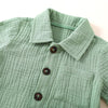 A light sage green baby boy cotton linen shirt with a collar and pocket.