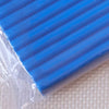 A close-up view of a blue polymer clay modeling tool or block under clear plastic packaging.