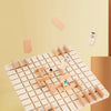 A wooden logical thinking game board with wooden pieces and a small figure, set against a light background.