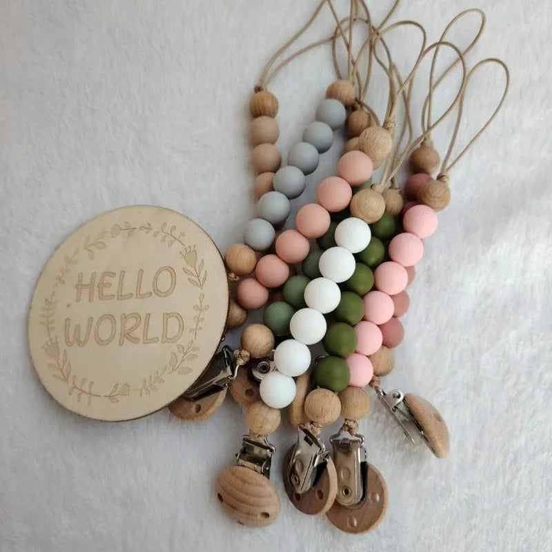 A string of wooden beads and silicone teether clips in natural wood tones and pastel colors.