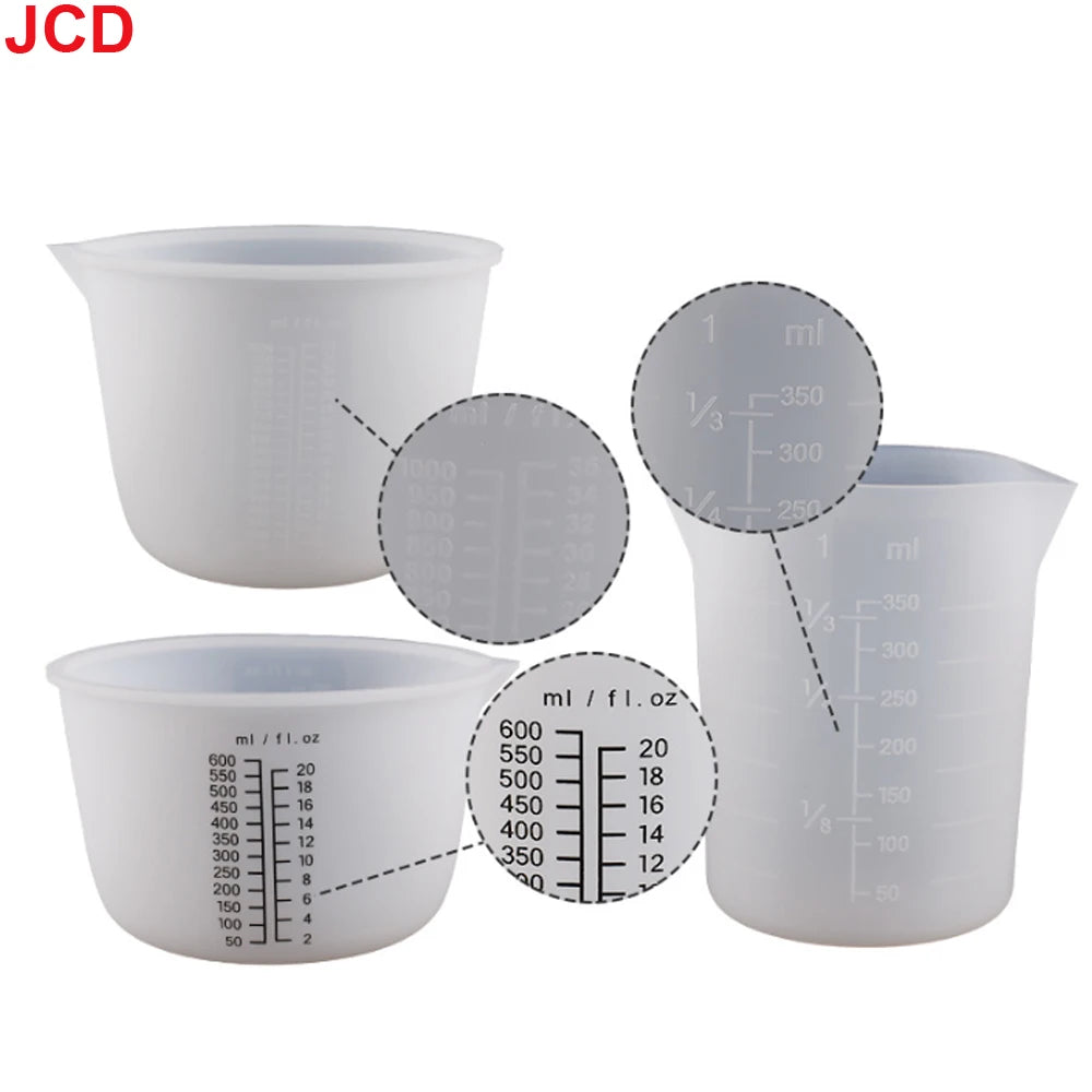 A set of clear silicone measuring cups with volume markings for resin and epoxy measurements.