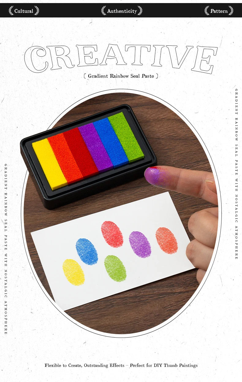 A hand holds a black ink pad with six rectangular gradient colored pads, showing various rainbow colors for crafting.