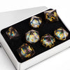A set of ten plum blossom liquid core resin dice in a silver box, featuring galaxy patterns and numbered faces.