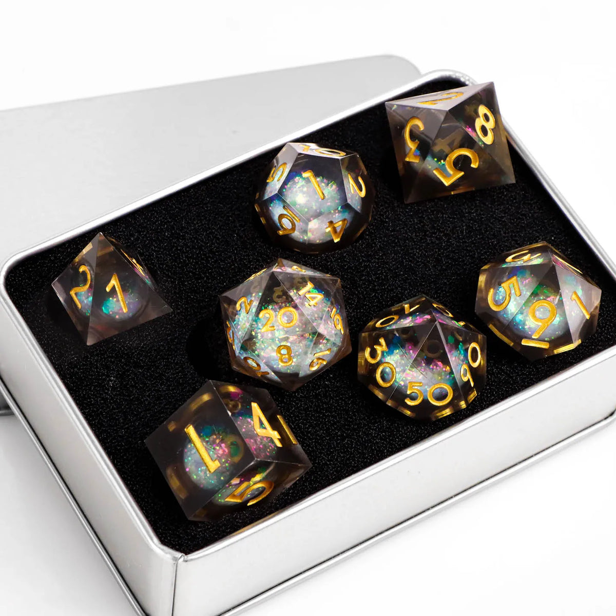 A set of ten plum blossom liquid core resin dice in a silver box, featuring galaxy patterns and numbered faces.
