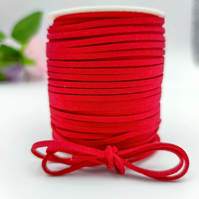 A roll of bright red velvet faux suede braided ribbon used for crafting and gift wrapping.