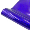 Close-up of a purple holographic glitter vinyl material rolled and curved.