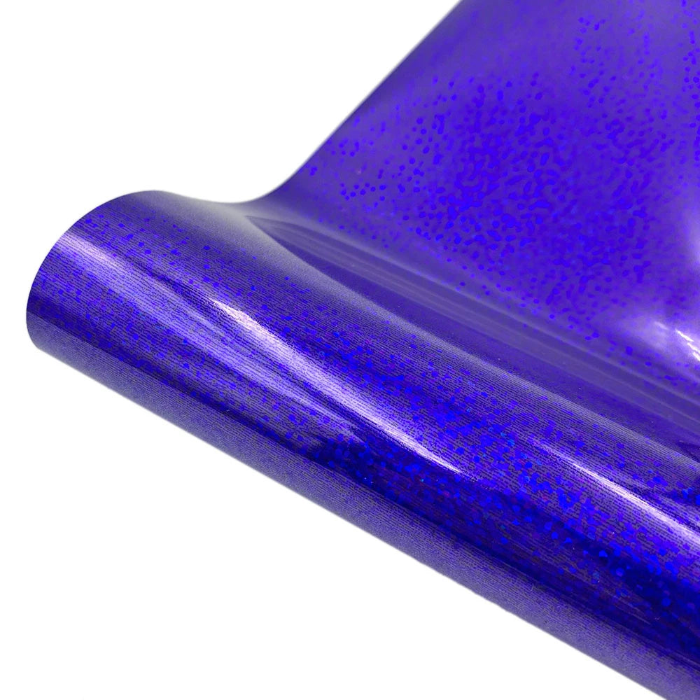 Close-up of a purple holographic glitter vinyl material rolled and curved.