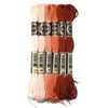 A set of six skeins of vibrant embroidery thread in various shades of orange and pink for cross stitch and DIY crafts