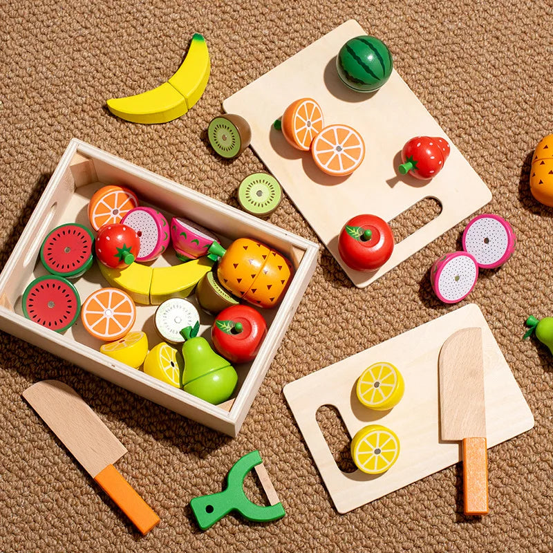 A wooden magnetic fruit cutting play set featuring various fruits like mango, orange, and apple on a light wooden board.