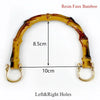 A curved resin faux bamboo handle with left and right holes, measuring 10cm long and 8.5cm high.