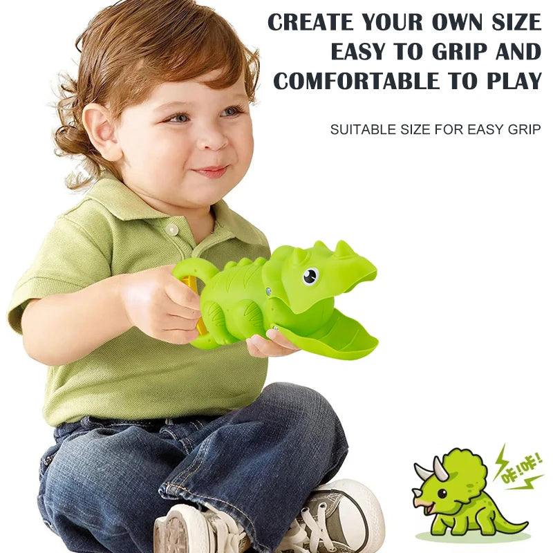A young child holds a green dinosaur toy, demonstrating its size and grip for play.