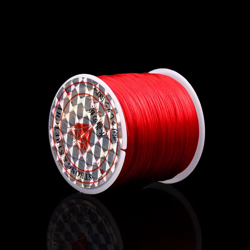 A roll of red elastic beading cord for stretch bracelets and necklaces