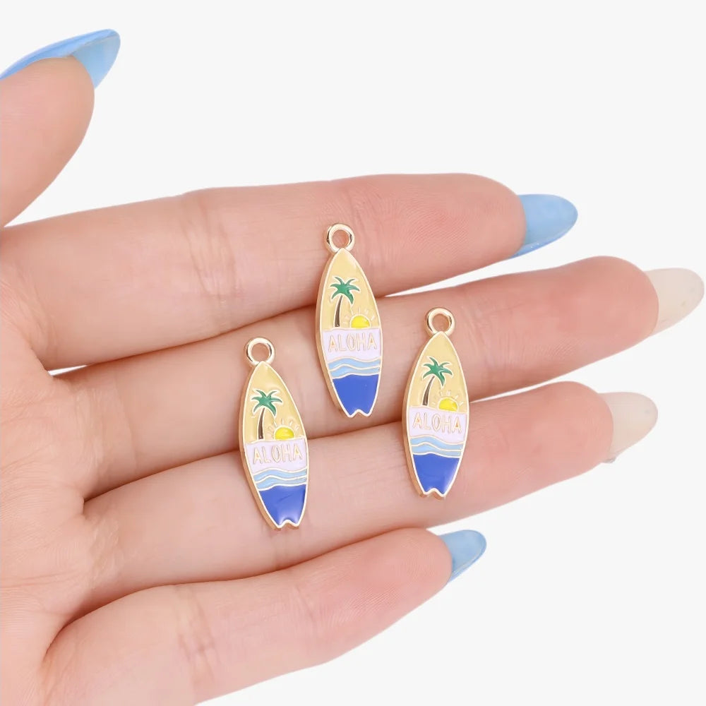 Gold-toned enamel charms shaped like tropical leaves and waves for jewelry making