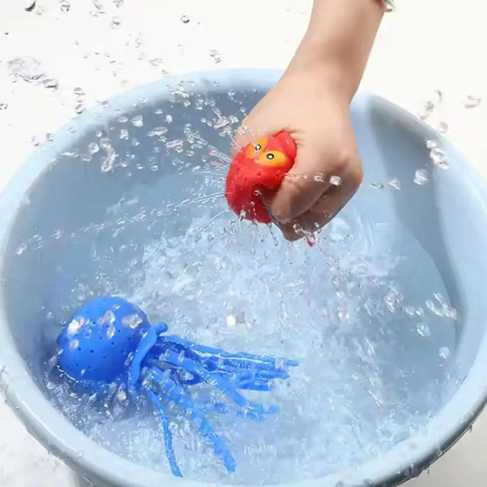 A hand is dipping a blue octopus bath toy into a bowl of water with ice cubes.