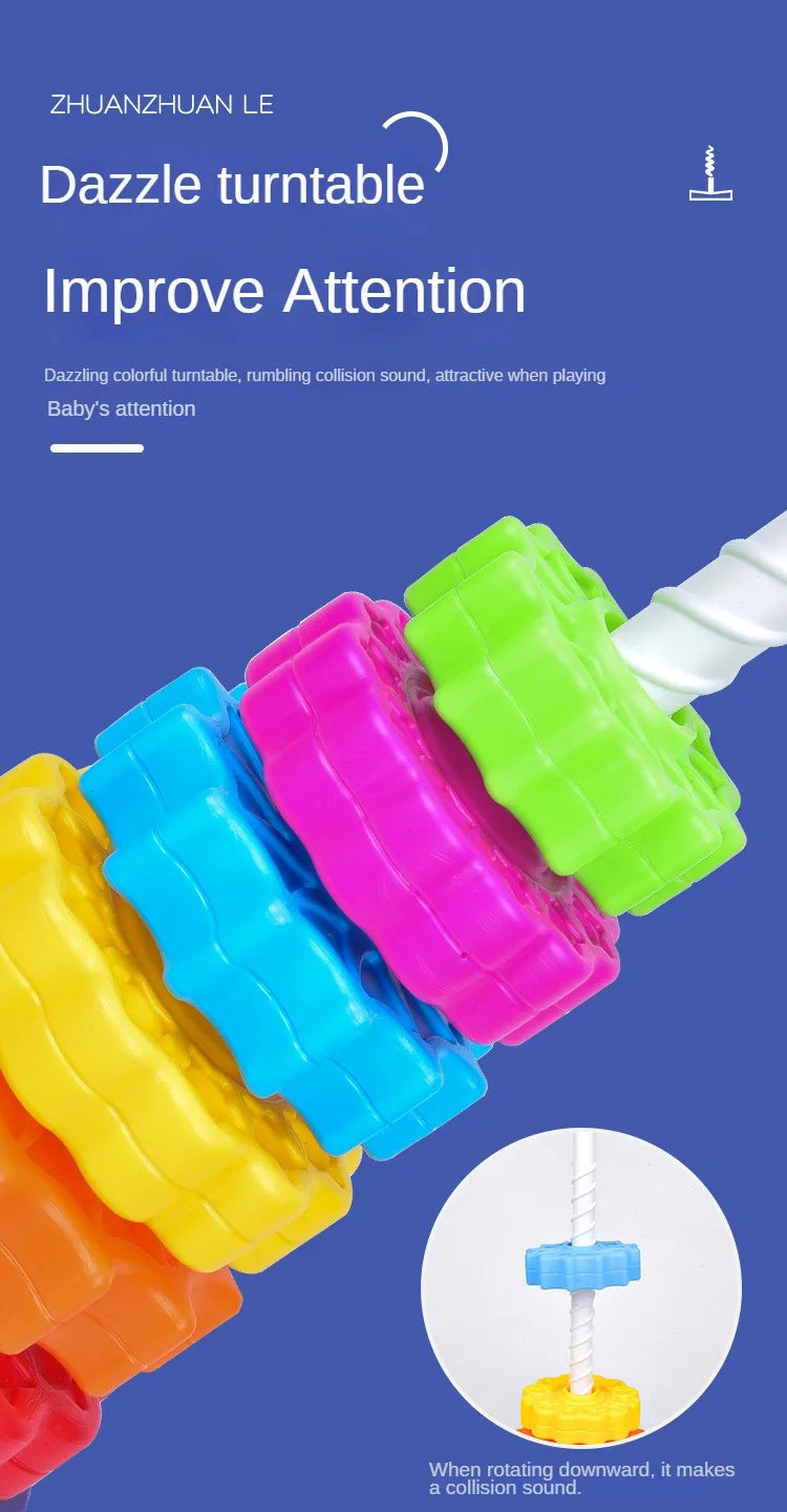 Colorful plastic stacking toy with various colored rings and a white piece, demonstrating a collision sound.