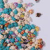 A collection of multicolor ocean turtle beads in various shades of white, blue, pink, and yellow for jewelry making.