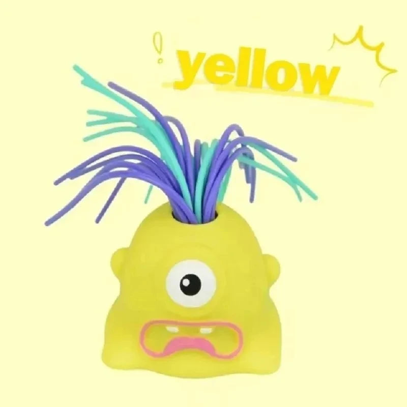 A yellow, screaming monster stress relief toy with purple hair and an angry expression.