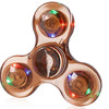 A translucent, multi-colored glow-in-the-dark LED fidget spinner with four rotating discs.