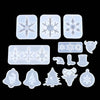 A collection of clear silicone molds featuring various snowflake and Christmas tree shapes for jewelry and craft projects.