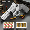 A silver pistol is shown alongside six gold bullet shells and twelve soft bullets for a spring-powered revolver dart blaster.
