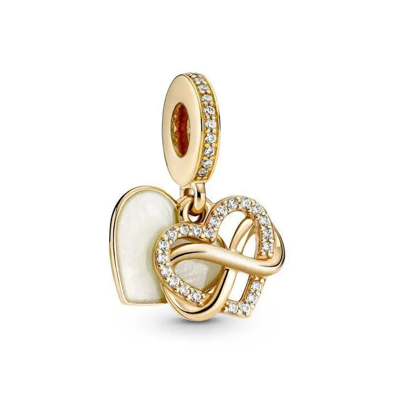 A gold-toned charm bracelet featuring pendants of an elephant, key, butterfly, and heart.