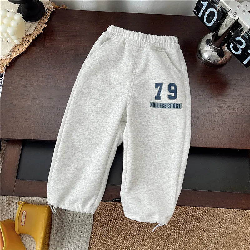 A light gray kids' 2-piece set featuring a long-sleeve sweater and sweatpants with the number 79 printed on the leg.