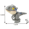 A gray finger dinosaur fidget toy with movable joints and a yellow eye.